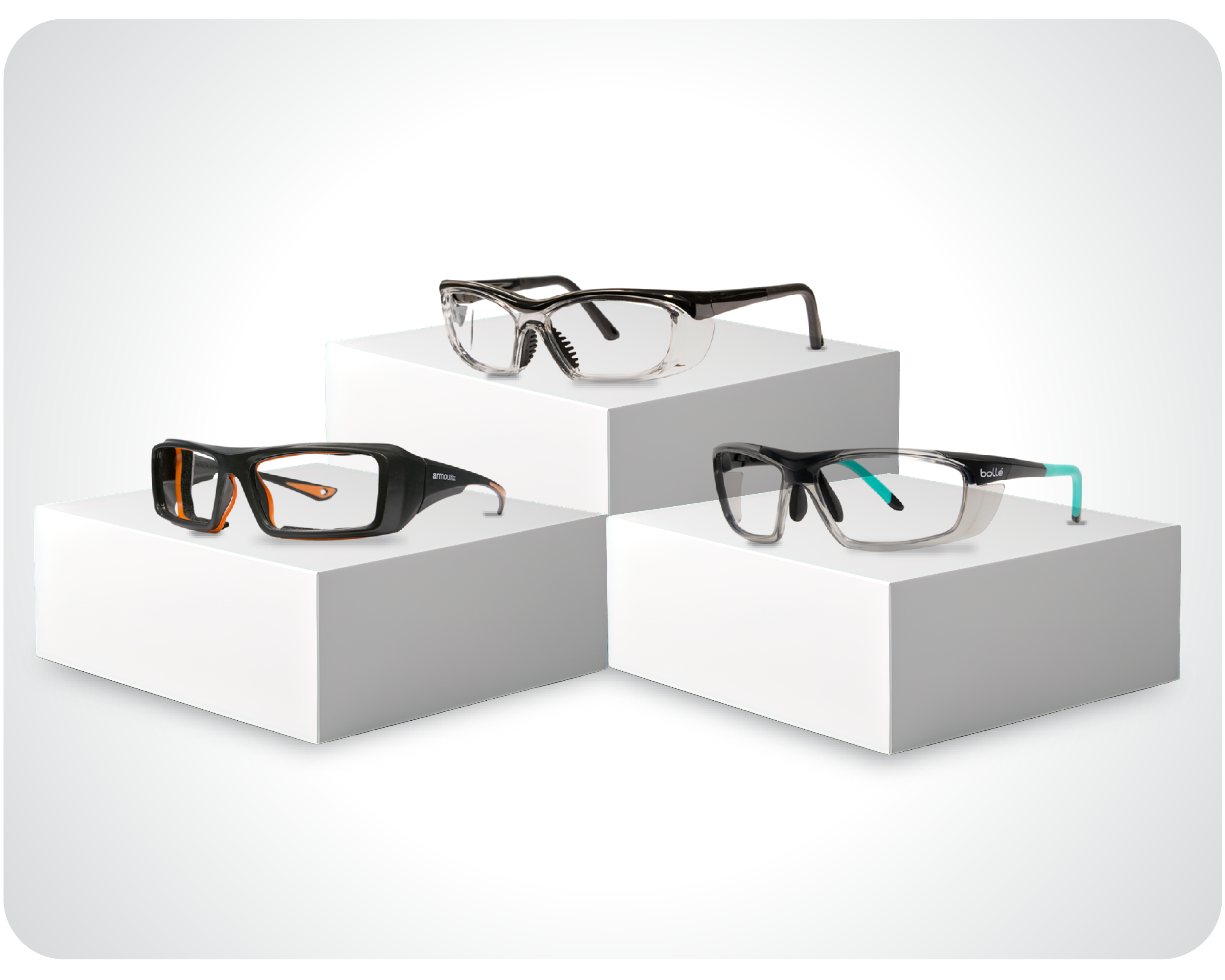 Prescription safety glasses in black, clear, and black-blue variants on white display blocks