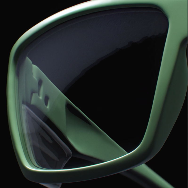 Green prescription safety glasses with a close-up on the prescription lens on black background