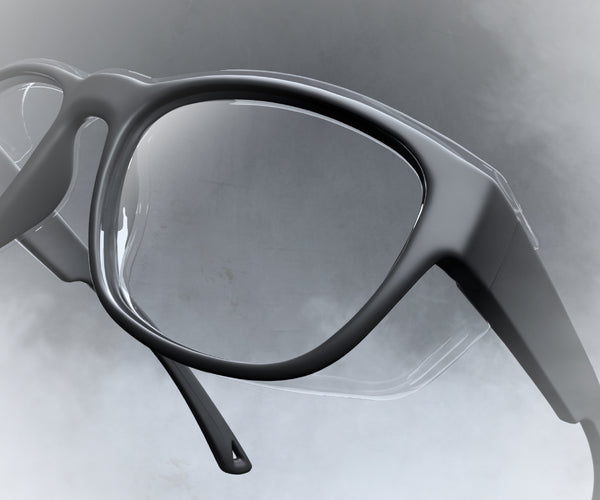 Prescription safety glasses with clear lenses on a light gray background with fog surrounding the frame
