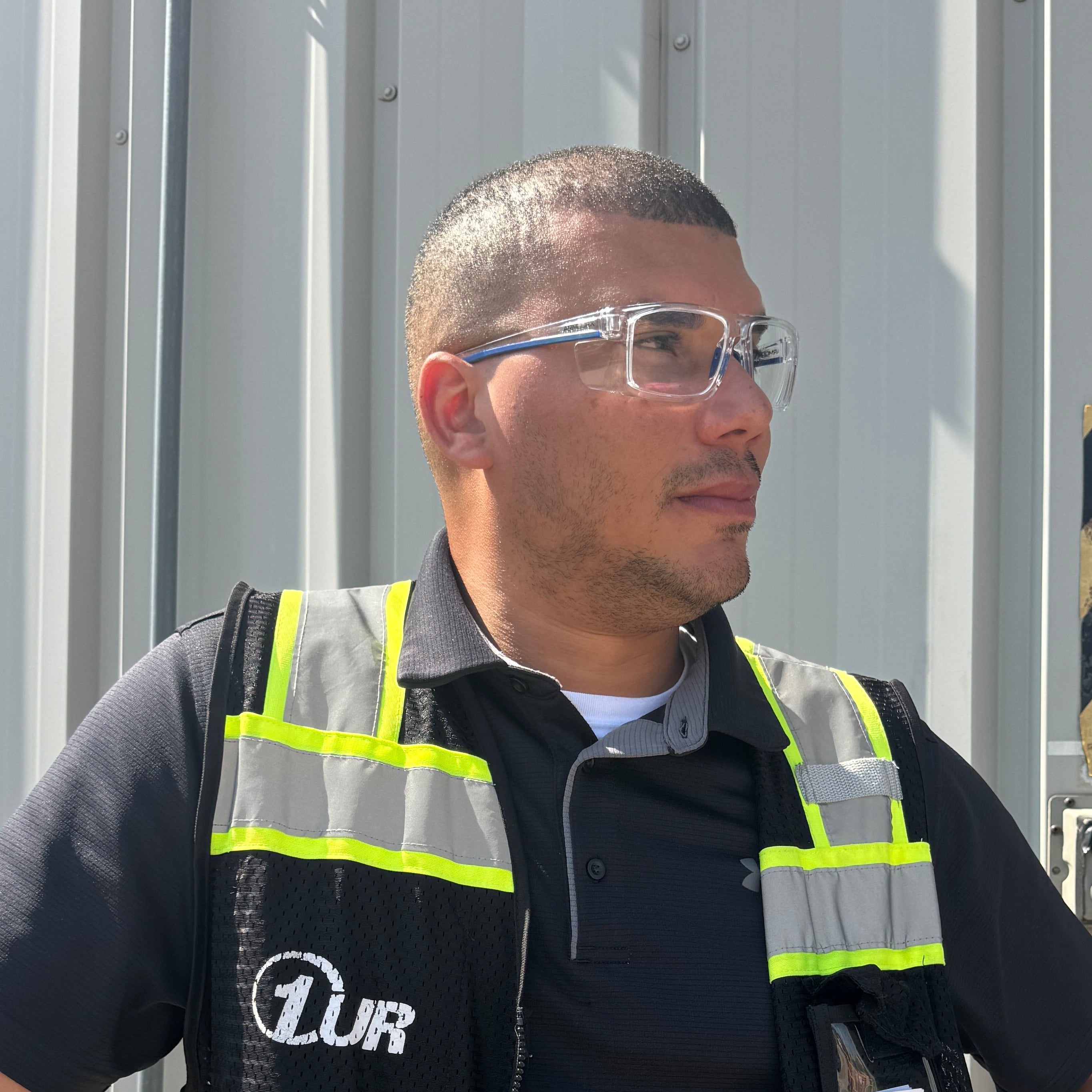 Man wearing a safety vest while wearing ArmouRx 5003 prescription safety glasses  in an industrial setting