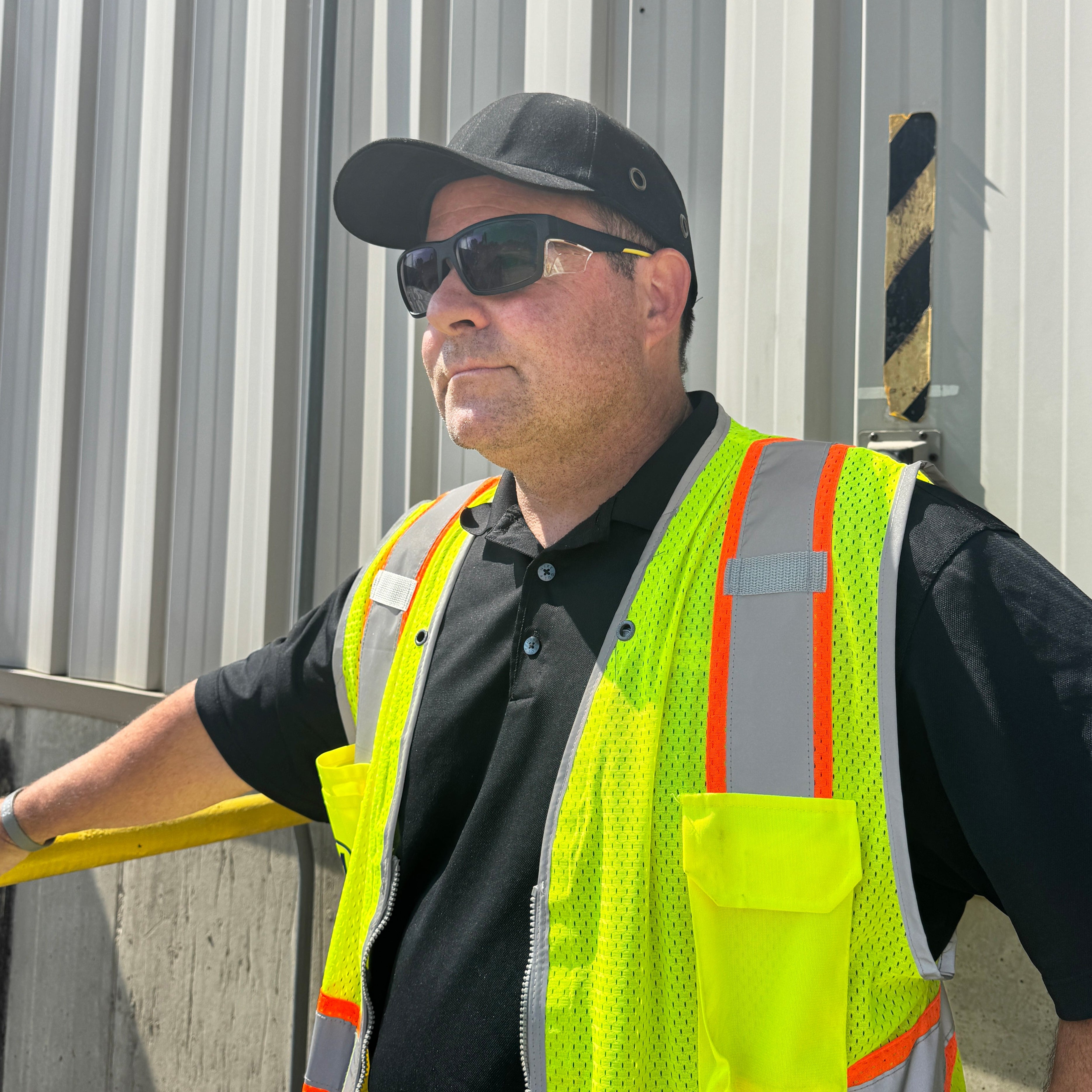 HiDXA003 prescription safety glasses in black worn by worker in hi-vis vest outdoors