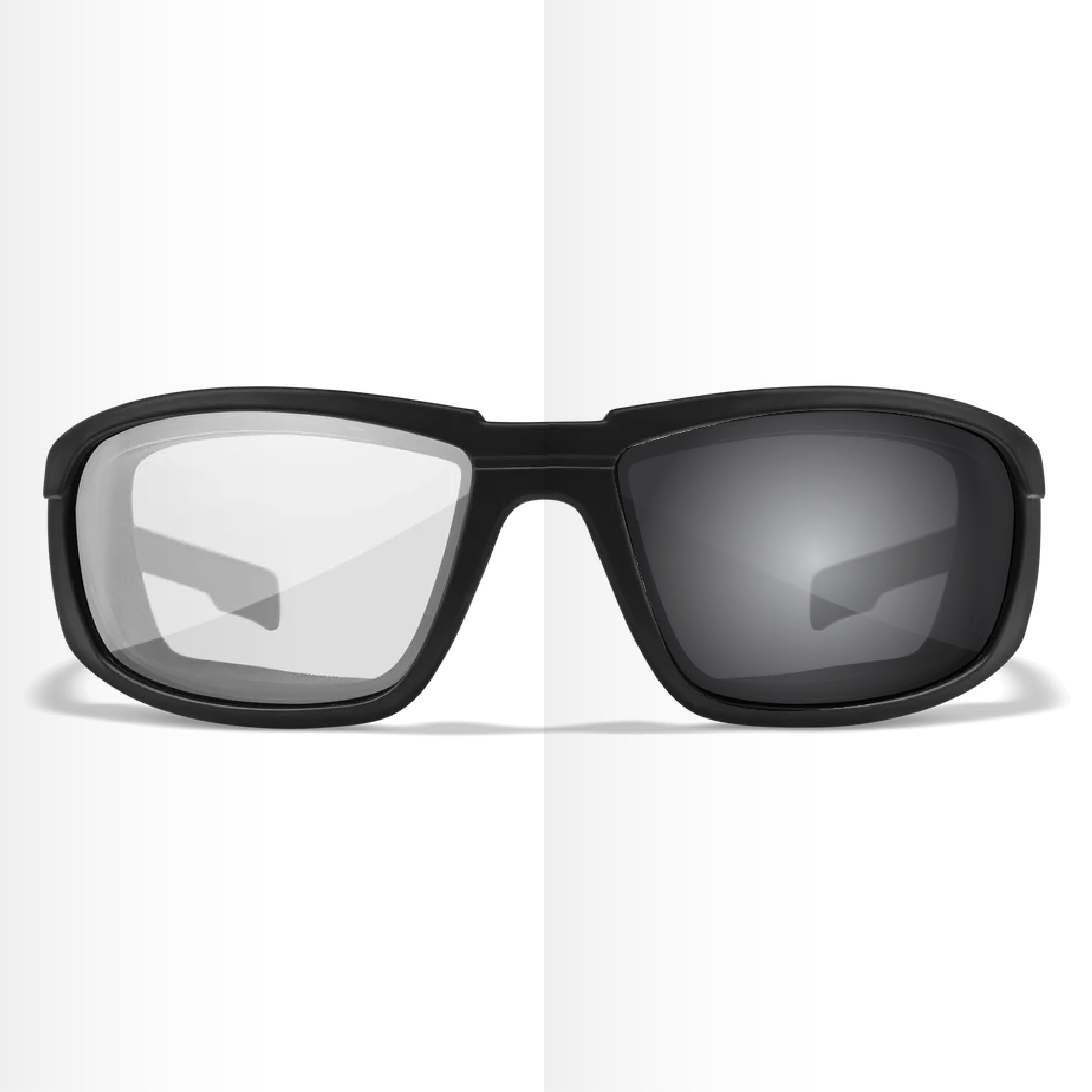 Pair of prescription safety glasses with one clear lens and one sunglasses lens on a white background